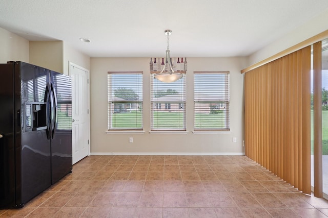 7850 Estancia Dr, Frisco, TX 75036 - unfurnished dining area featuring baseboards and light tile patterned floors