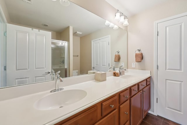 7850 Estancia Dr, Frisco, TX 75036 - full bath featuring an enclosed shower, double vanity, and tile patterned flooring