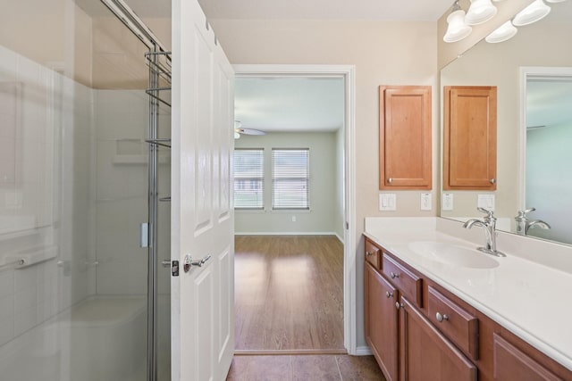 7850 Estancia Dr, Frisco, TX 75036 - bathroom with a shower stall, vanity, ceiling fan, and wood finished floors