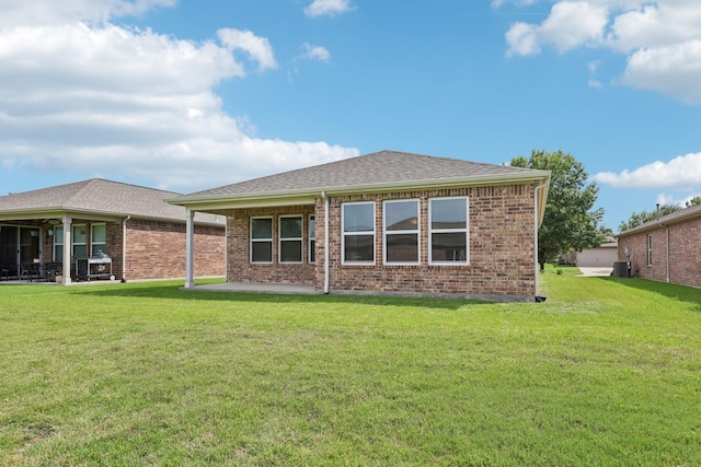 7850 Estancia Dr, Frisco, TX 75036 - rear view of property featuring a patio, a yard, brick siding, and a shingled roof
