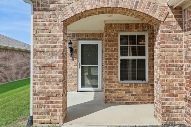 7850 Estancia Dr, Frisco, TX 75036 - view of exterior entry featuring brick siding and a patio