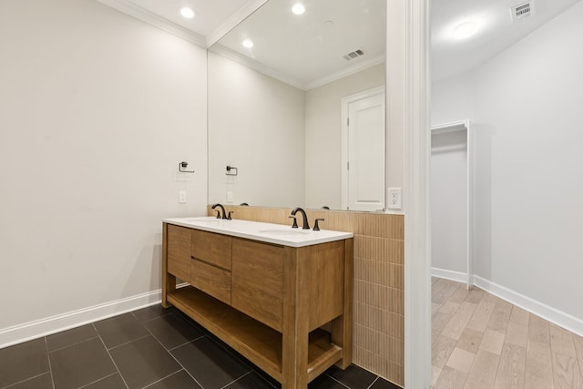 2300 Leonard St Unit 305, Dallas, TX 75201 - bathroom featuring ornamental molding, double vanity, recessed lighting, and tile walls