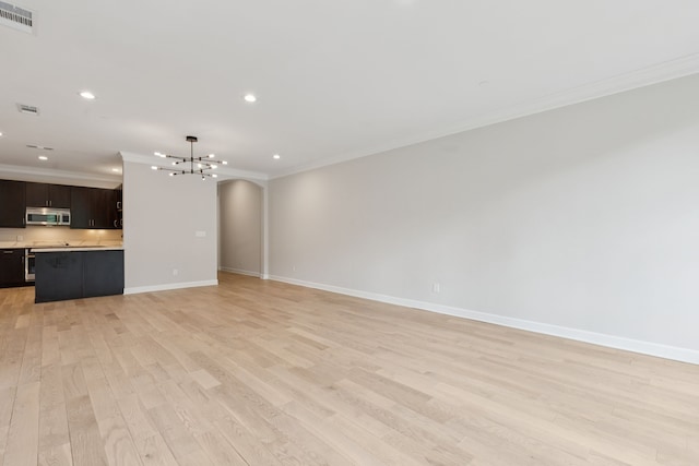 2300 Leonard St Unit 305, Dallas, TX 75201 - unfurnished living room with a chandelier, crown molding, light wood-style flooring, and recessed lighting