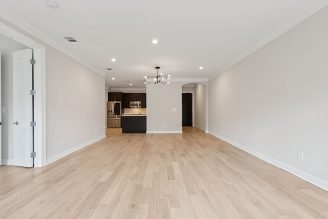 2300 Leonard St Unit 305, Dallas, TX 75201 - unfurnished living room featuring a chandelier, arched walkways, recessed lighting, ornamental molding, and light wood-style floors