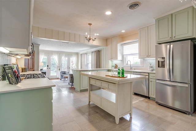 2012 Carleton Ave, Fort Worth, TX 76107 - kitchen with appliances with stainless steel finishes, healthy amount of natural light, light countertops, decorative backsplash, and crown molding