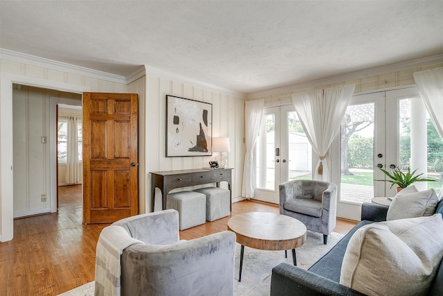 2012 Carleton Ave, Fort Worth, TX 76107 - living room with french doors, ornamental molding, wood finished floors, healthy amount of natural light, and a textured ceiling