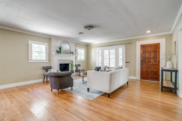2012 Carleton Ave, Fort Worth, TX 76107 - living area featuring crown molding, light wood-type flooring, a brick fireplace, a textured ceiling, and recessed lighting