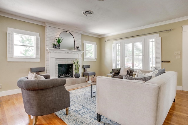 2012 Carleton Ave, Fort Worth, TX 76107 - living room with ornamental molding, plenty of natural light, light wood finished floors, and a fireplace