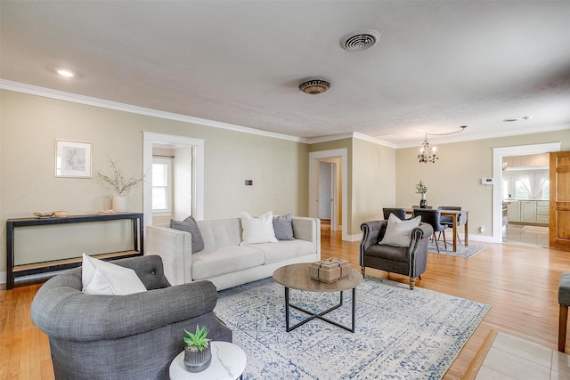 2012 Carleton Ave, Fort Worth, TX 76107 - living room with a chandelier, crown molding, and light wood-style flooring