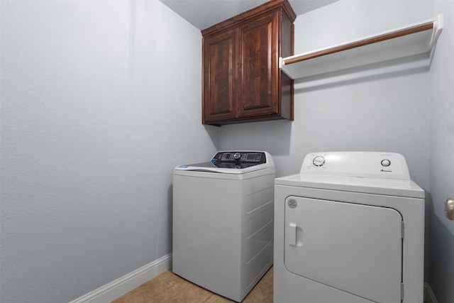 6308 Harold Creek Dr, Fort Worth, TX 76179 - laundry area with cabinet space, washing machine and clothes dryer, and light tile patterned floors