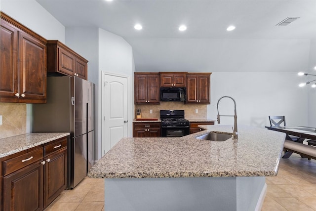 6308 Harold Creek Dr, Fort Worth, TX 76179 - kitchen featuring black appliances, light tile patterned flooring, decorative backsplash, an island with sink, and recessed lighting
