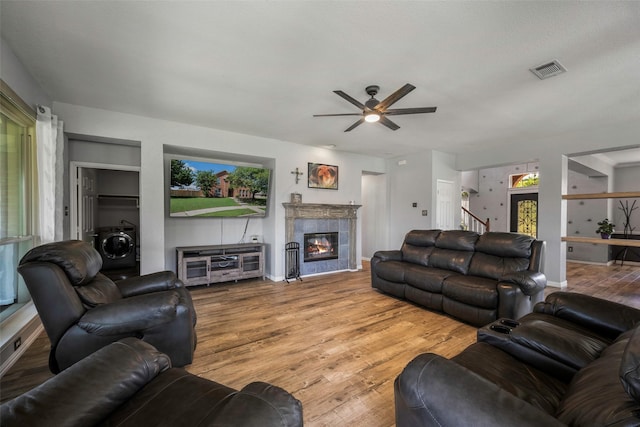 7305 Meadowwood Dr, Rowlett, TX 75089 - living area with a ceiling fan, wood finished floors, a fireplace, and stairway