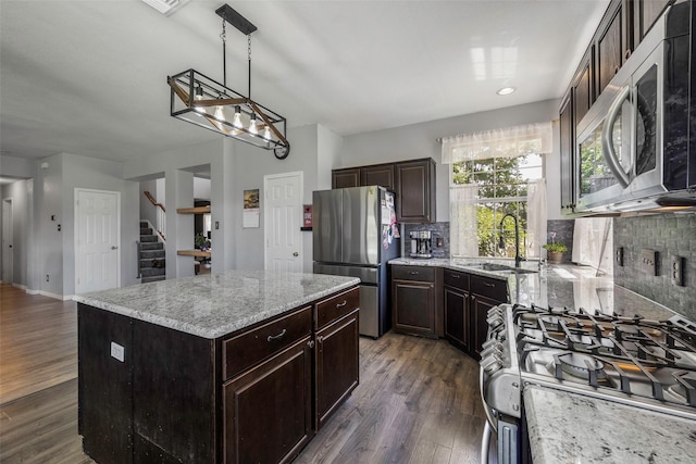 7305 Meadowwood Dr, Rowlett, TX 75089 - kitchen with stainless steel appliances, decorative backsplash, a center island, and dark wood-style flooring