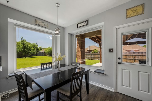 7305 Meadowwood Dr, Rowlett, TX 75089 - dining room featuring dark wood-type flooring and baseboards