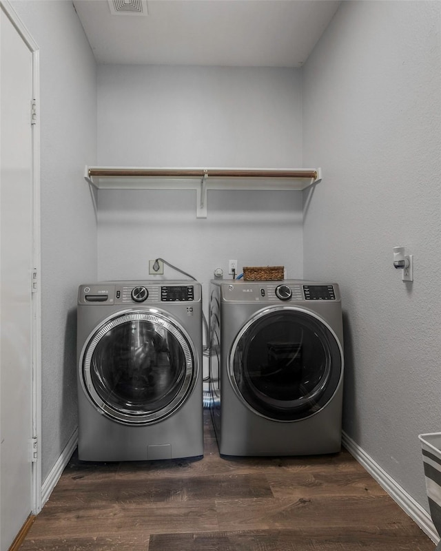 7305 Meadowwood Dr, Rowlett, TX 75089 - laundry room featuring washer and clothes dryer and wood finished floors
