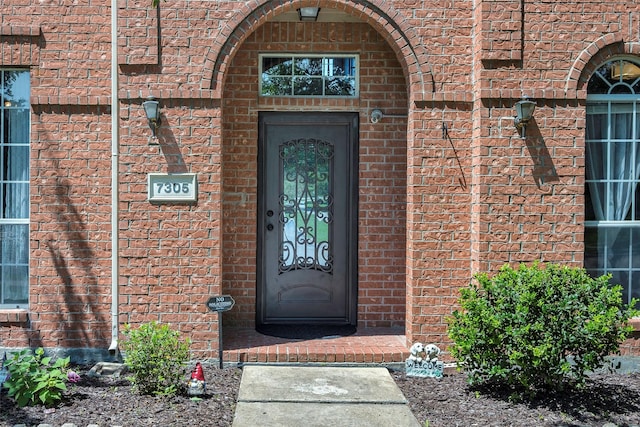 7305 Meadowwood Dr, Rowlett, TX 75089 - view of exterior entry featuring brick siding