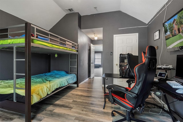 7305 Meadowwood Dr, Rowlett, TX 75089 - bedroom with lofted ceiling, an office area, and wood finished floors