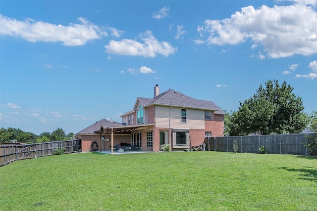 7305 Meadowwood Dr, Rowlett, TX 75089 - back of property featuring brick siding, a patio, a fenced backyard, and a chimney
