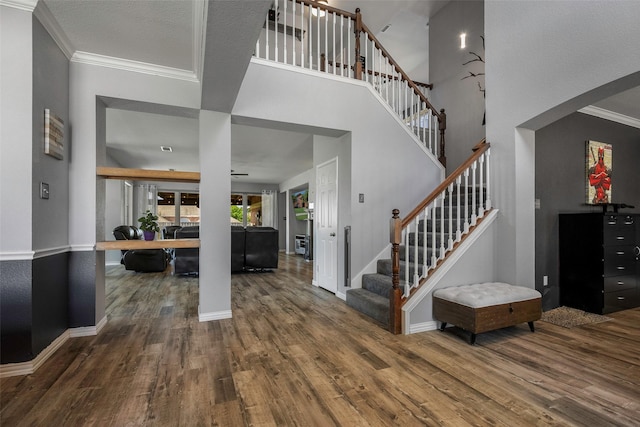 7305 Meadowwood Dr, Rowlett, TX 75089 - entryway with wood finished floors, stairway, and crown molding