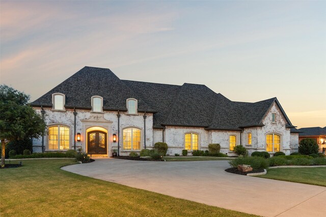 1800 Aspen St, Prosper, TX 75078 - french country inspired facade with french doors, a front lawn, curved driveway, and a shingled roof
