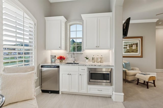 1800 Aspen St, Prosper, TX 75078 - kitchen with stainless steel appliances, crown molding, tasteful backsplash, white cabinetry, and light stone countertops
