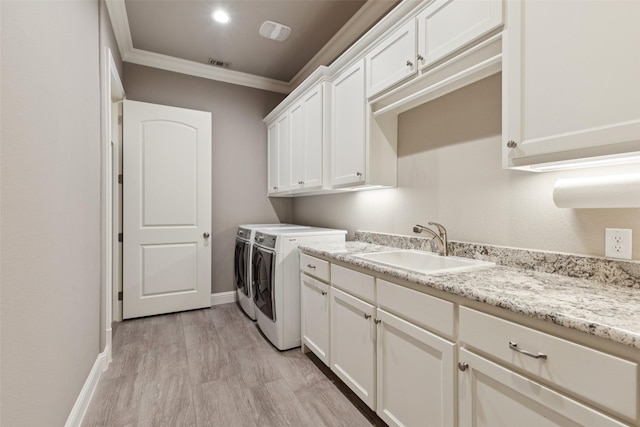 1800 Aspen St, Prosper, TX 75078 - washroom with washer and dryer, cabinet space, ornamental molding, and light wood finished floors