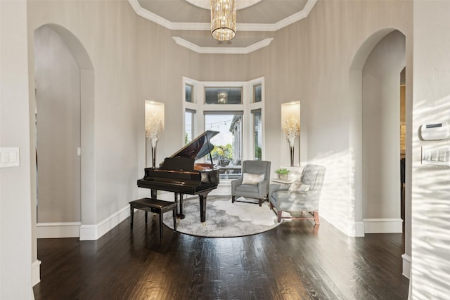 1800 Aspen St, Prosper, TX 75078 - living area featuring arched walkways, wood finished floors, a towering ceiling, and a chandelier