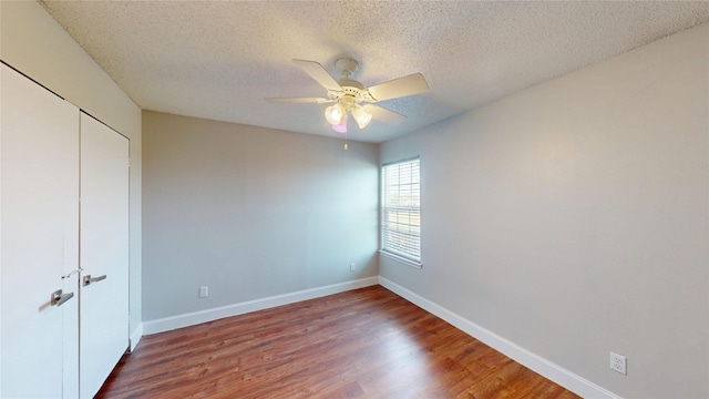 328 Antietam Way, Mesquite, TX 75149 - unfurnished bedroom featuring wood finished floors, a closet, a textured ceiling, and ceiling fan