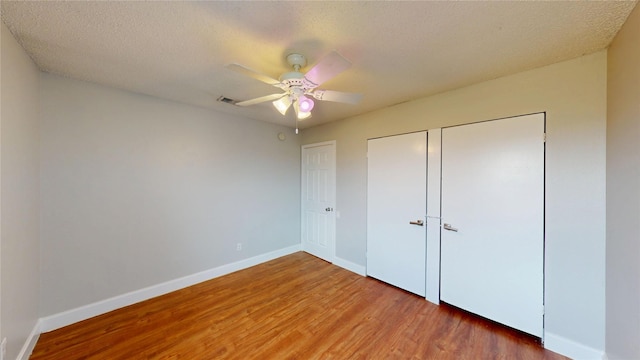 328 Antietam Way, Mesquite, TX 75149 - unfurnished bedroom with wood finished floors, a closet, ceiling fan, and a textured ceiling