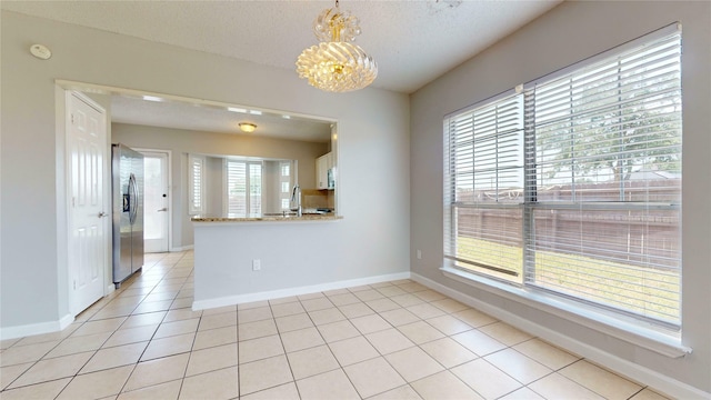 328 Antietam Way, Mesquite, TX 75149 - empty room with a chandelier, light tile patterned floors, a smoke detector, and a textured ceiling