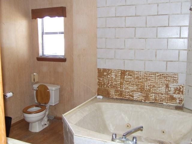 1729 Lindy Ln, Irving, TX 75060 - bathroom with a tub with jets and wood finished floors