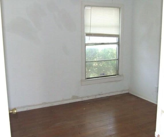 1729 Lindy Ln, Irving, TX 75060 - empty room with wood finished floors and baseboards