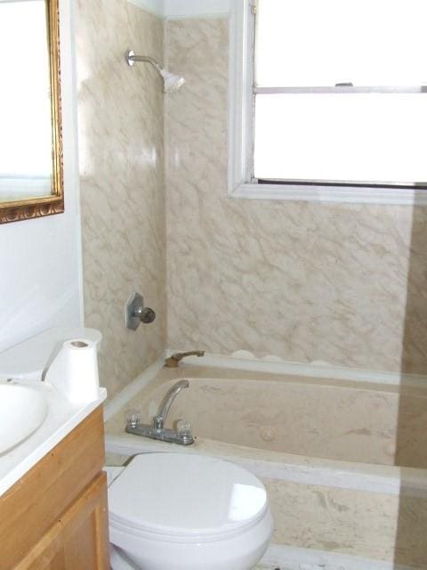 1729 Lindy Ln, Irving, TX 75060 - full bathroom featuring healthy amount of natural light, vanity, and a combined bath / shower with marble appearance