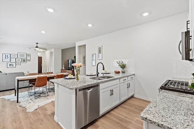 1512 Bennington Ln, Celina, TX 75009 - kitchen featuring appliances with stainless steel finishes, a peninsula, backsplash, open floor plan, and white cabinets