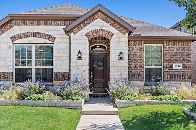 1512 Bennington Ln, Celina, TX 75009 - doorway to property featuring brick siding, a shingled roof, stone siding, and a yard
