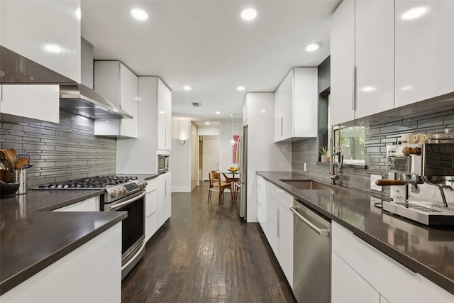3138 Whirlaway Rd, Dallas, TX 75229 - kitchen featuring appliances with stainless steel finishes, dark countertops, modern cabinets, decorative backsplash, and recessed lighting