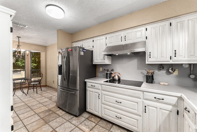 4610 County Road 862, Mckinney, TX 75071 - kitchen with stainless steel fridge, black electric stovetop, a textured ceiling, under cabinet range hood, and white cabinetry