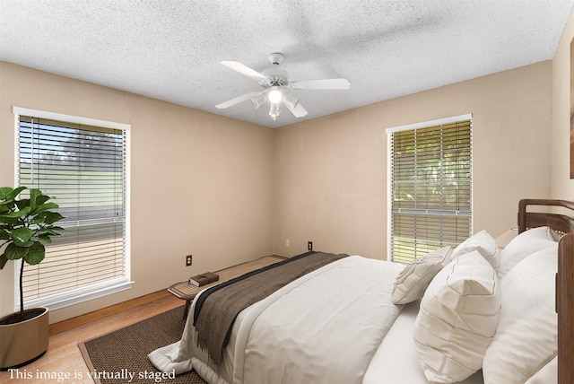 4610 County Road 862, Mckinney, TX 75071 - bedroom with wood finished floors, a textured ceiling, and ceiling fan