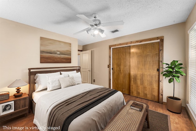 4610 County Road 862, Mckinney, TX 75071 - bedroom featuring wood finished floors, a closet, a textured ceiling, and a ceiling fan