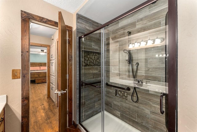 4610 County Road 862, Mckinney, TX 75071 - ensuite bathroom featuring a stall shower, vanity, a ceiling fan, and wood finished floors