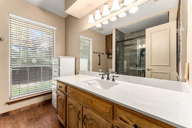 4610 County Road 862, Mckinney, TX 75071 - bathroom featuring vanity, a stall shower, healthy amount of natural light, and wood finished floors