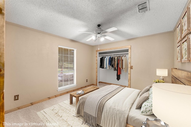4610 County Road 862, Mckinney, TX 75071 - bedroom featuring ornamental molding, light carpet, a textured ceiling, a closet, and ceiling fan