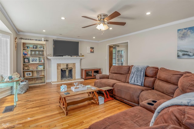 171 Albert Ave, Shreveport, LA 71105 - living area with a tile fireplace, a ceiling fan, light wood-type flooring, recessed lighting, and ornamental molding