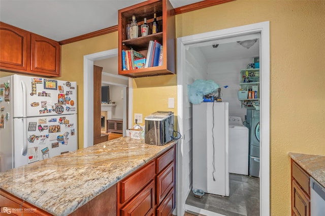 171 Albert Ave, Shreveport, LA 71105 - kitchen featuring freestanding refrigerator, washing machine and clothes dryer, a peninsula, light stone countertops, and dishwashing machine