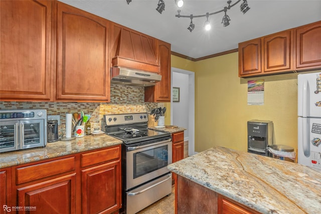 171 Albert Ave, Shreveport, LA 71105 - kitchen with stainless steel range with electric stovetop, range hood, tasteful backsplash, freestanding refrigerator, and light stone counters