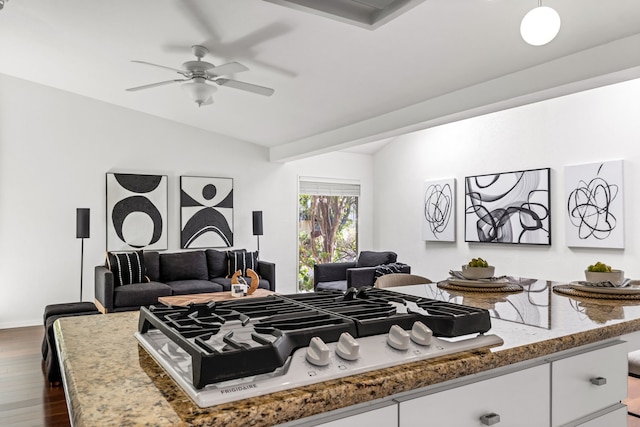 10305 Robindale Dr, Dallas, TX 75238 - kitchen featuring lofted ceiling, dark wood-style floors, stainless steel gas cooktop, white cabinets, and a ceiling fan