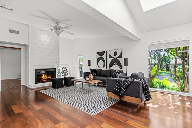 10305 Robindale Dr, Dallas, TX 75238 - living room with a tile fireplace, wood finished floors, a ceiling fan, high vaulted ceiling, and a skylight