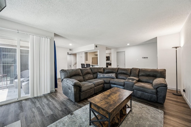6050 Melody Ln Unit 107, Dallas, TX 75231 - living area with wood finished floors, a textured ceiling, recessed lighting, and stairs