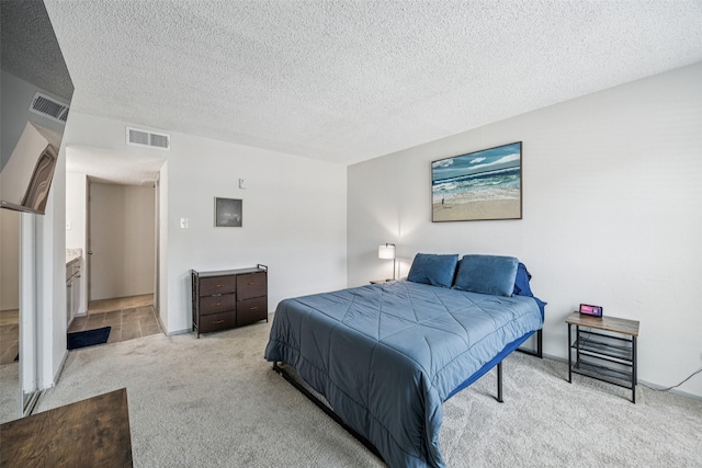 6050 Melody Ln Unit 107, Dallas, TX 75231 - bedroom with light colored carpet and a textured ceiling