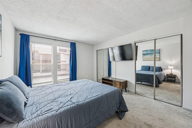 6050 Melody Ln Unit 107, Dallas, TX 75231 - carpeted bedroom featuring two closets and a textured ceiling